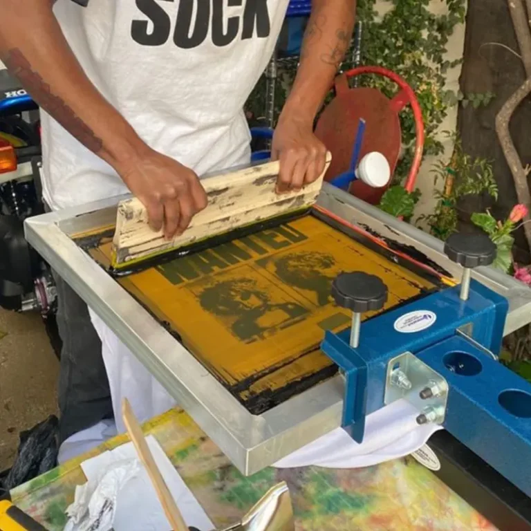 Screen printing press applying vivid ink to custom t-shirts